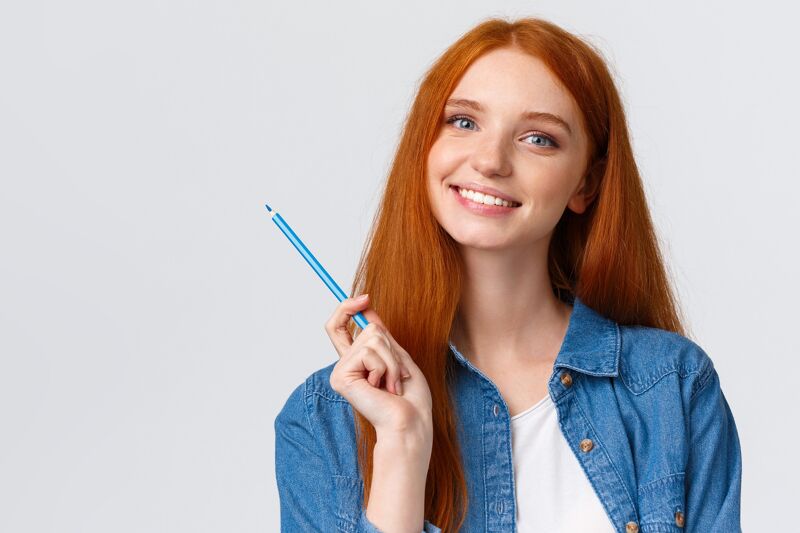 Portrait of a girl holding a pencil