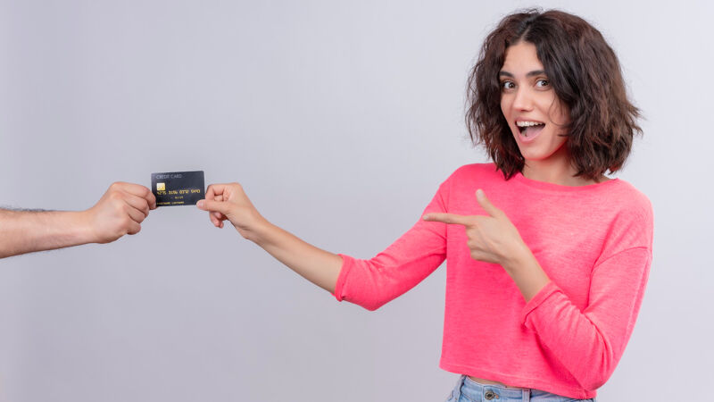 Woman handing over a credit card